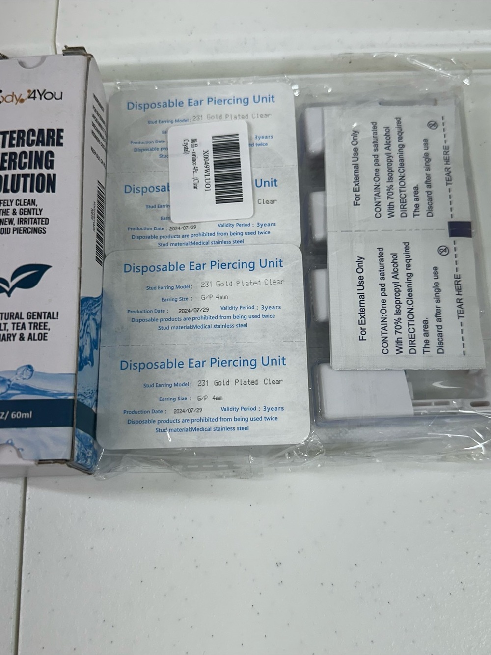 Disposable ear piercing kits (8) with aftercare solution